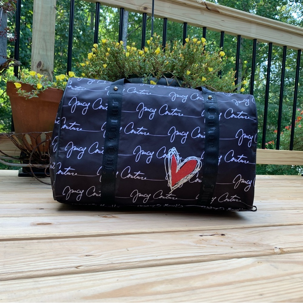 Juicy Couture duffel bag. Zippered closure. Black with hot pink interior.